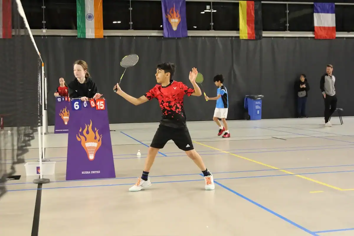 Doubles match in front of the umpire chair and national flags at Junior Master EBA 2026