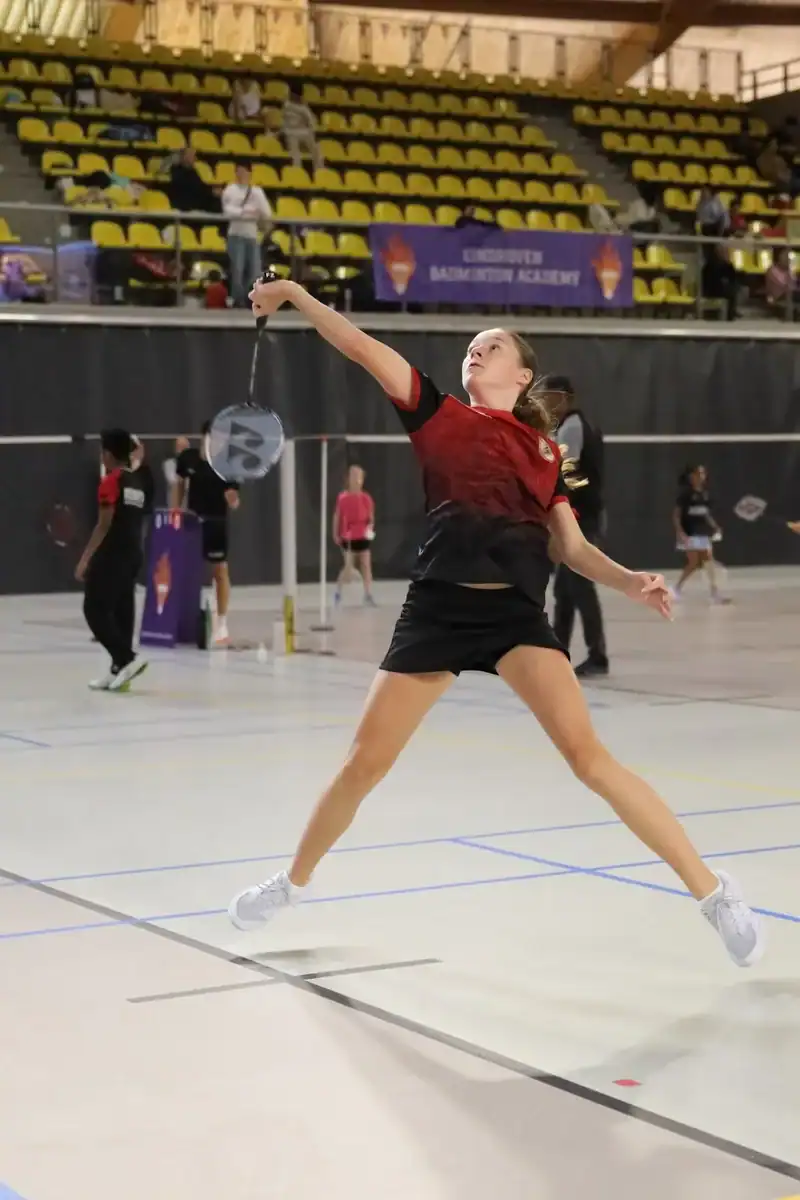 Girl stretching for the shuttle in a singles match at Junior Master EBA 2026