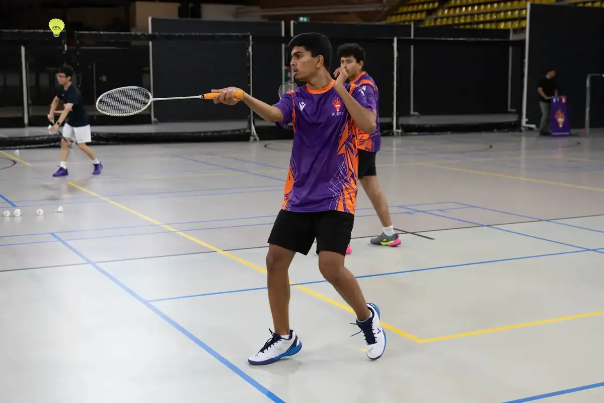Rudra United player hitting a forehand in a singles match