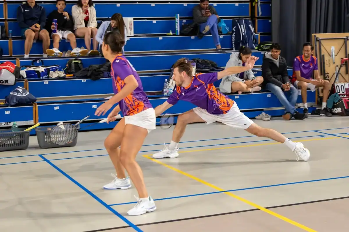 Rudra United player lunging for the shuttle in a doubles match